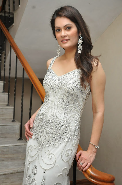 Anjela Kumar in a stunning white sleeveless dress