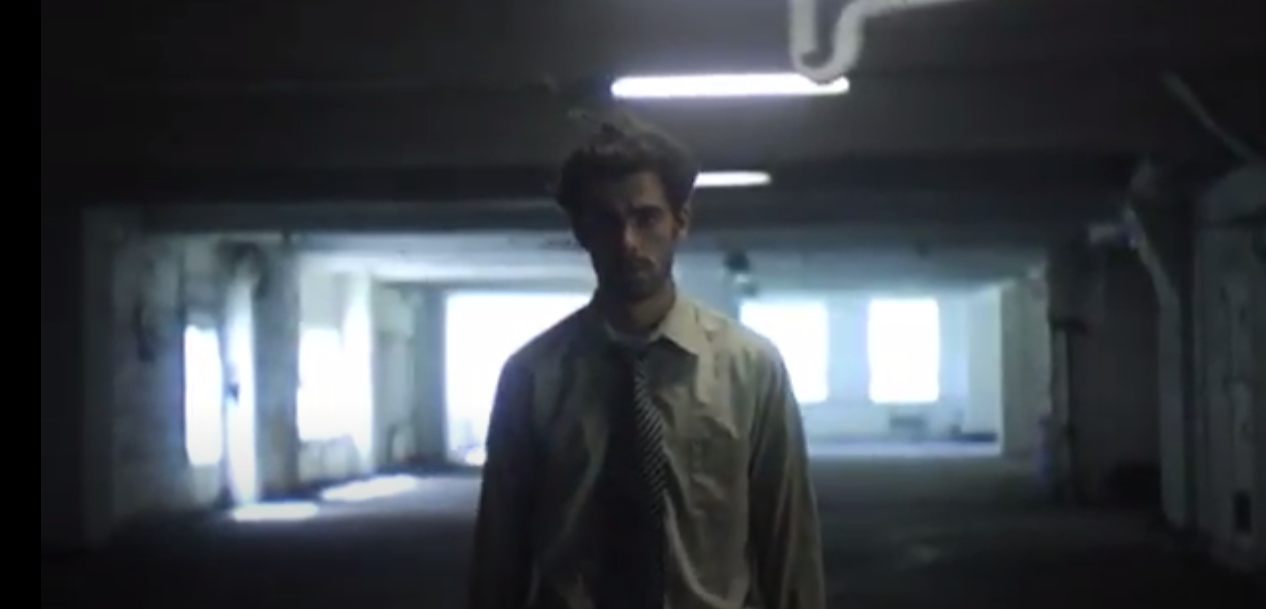 A man alone in a dark empty building