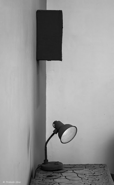 A Black and White Minimalist Photograph of a Table Lamp shot at Jawahar Kala Kendra, Jaipur.