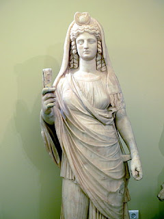 Statue of Isis-Persephone, the queen of  the underworld, holding a sistrum, in the  Archaeological Museum in Herakleion.