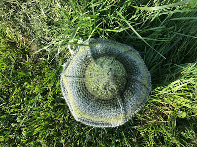 picture of the hut in the grass shown from the top of the roof.