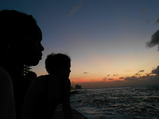 Two women on the Malecón silhouetted against the sunset