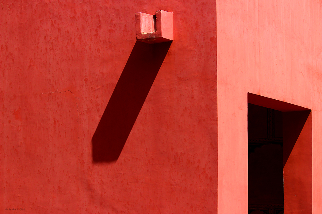 Minimalist Photos Open Door and Water Outlet on a Red Wall
