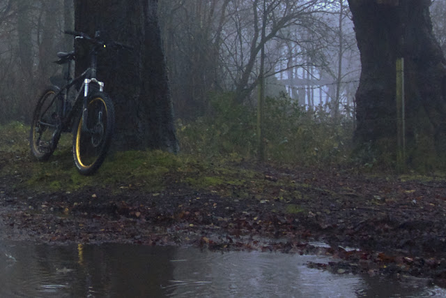 cycling in the rain by a puddle