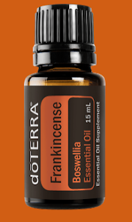 Bottle of dōTERRA Frankincense essential oil for skin health, relaxation, and mood enhancement.