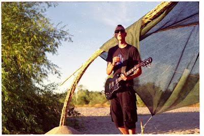 Fred Rosa playing guitar on the sand