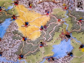 Elfenland - The board and a lone teenage boot with coloured columns indicating which cities are still to be visited by the players