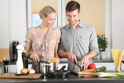 man and woman cooking dinner