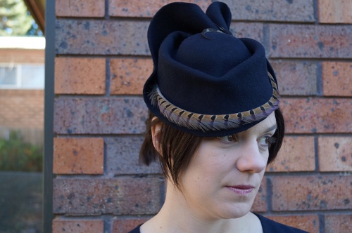 Navy wool felt blocked hat with pheasant feather