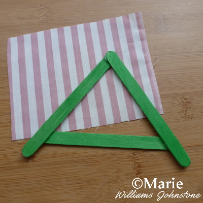 green triangular roof made with wooden sticks and fabric