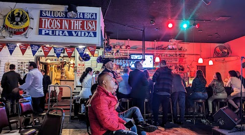 A relatively small crowd enjoys the match in chairs and at the bar