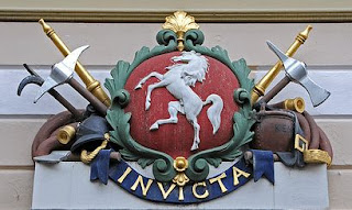 Invicta on the shield above the entrance to the old post office in Canterbury High Street