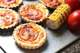 Food Lust People Love: These cheesy grilled corn tartlets boast grilled fresh corn, melty Saint Félicien cheese and a pretty slice of tomato on top, baked up in a flakey puff pastry crust. We ate these little beauties as a main course, alongside salad and green beans, but they would also be perfect for a special tea party or brunch.