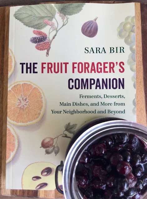 Fruit Foragers Companion book with a jar of Roasted Maple Blueberries.