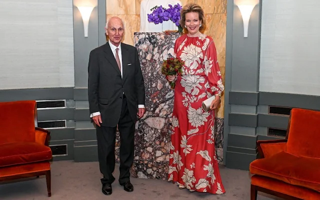 Queen Mathilde wore a new floral print long sleeve gown by Natan Couture. Armani clutch bag and Armani shoes