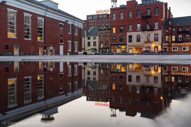 Portland, Maine August 2022 photo by Corey Templeton. Reflections of upper Free Street in a large puddle.