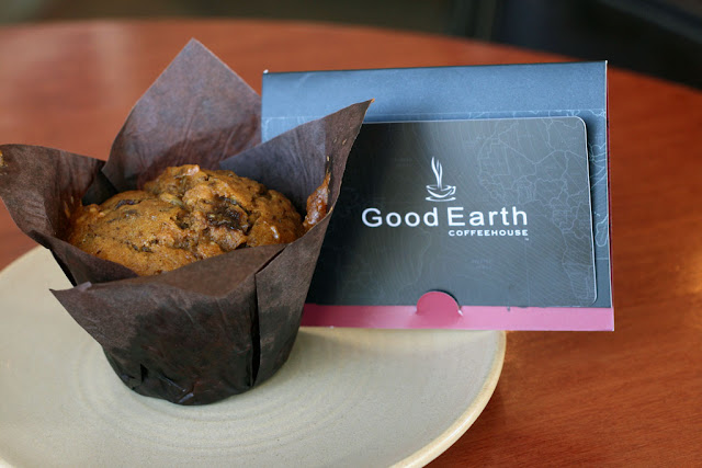 Pumpkin Spice Muffin on a plate with a Good Earth giftcard on top. 