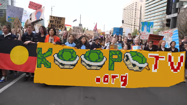 Global climate change strike protestors KoopaTV protect sign