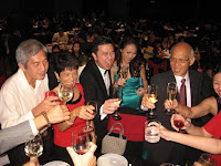 Abel and Fiona toasting with their guests