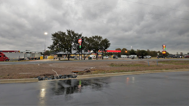 Rain and slow gas at the Flying J in Texarkana, off I-30. Arkansas. October 2022. Credit: Mzuriana.