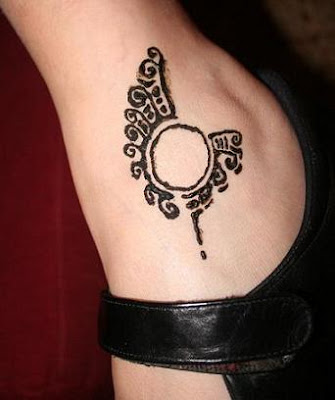 Tattoo number five: The body art on her back joins ones on her hip, ankle,