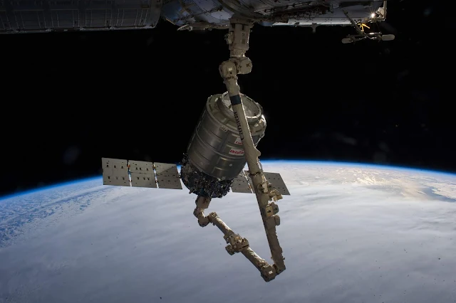 Here-is-a-NASA-image-of-the-Nanossatisfia-the-Orbital-Sciences-Corp-Cygnus-commercial-cargo-craft-on-the-robotic-arm-of-the-ISS.