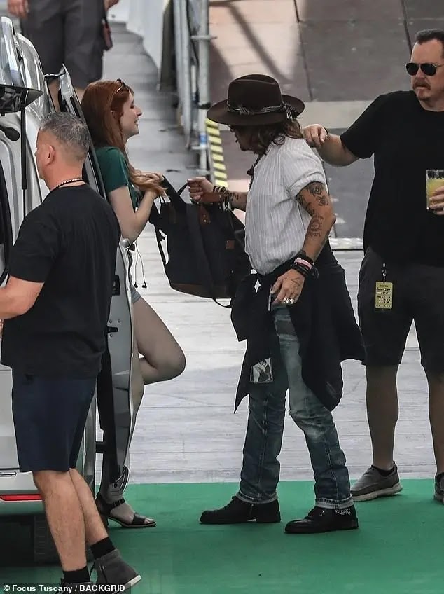 In pictures, Johnny Depp appears "happy" with a mysterious woman in Italy After his victory over his ex-wife Amber Heard in a defamation lawsuit, the news of the Hollywood star, Johnny Depp, continues to top the public's attention, this time with his appearance with a "mysterious" red-haired woman.  The cameras spotted Johnny Depp smiling and looking happy, accompanied by a charming girl, the moment he arrived at the rehearsal at the Arena Santa Giuliana in Italy, in preparation for his participation in the Umbria Jazz Festival, before the start of the concert yesterday, Sunday.  The famous star was also wearing jeans with a white T-shirt, which he coordinated with a brown hat, and hid his eyes with blue glasses.  The unknown woman who accompanied him, walking behind him, was also happy, and wore short jeans with a green T-shirt, brown open shoes, and was carrying a backpack.  Johnny participated in the Umbria Jazz Festival as a special guest at Jeff Beck's concert at the festival, which was held on Sunday.  After the rehearsal, the international star was said to have returned to the Profani Hotel in Perugia, Italy, where the red-haired girl was said to be staying at the same hotel, according to the British newspaper, Daily Mail.  Johnny's latest appearance comes after the release of his new album 18, in which he co-stars with Jeff Beck, as well as after he achieved a new victory in the lawsuit he filed against his ex-wife Amber Heard, specifically after the judiciary rejected her legal team's request for a retrial over allegations that there was an error.