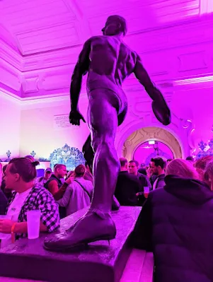 Bronze sculpture of a muscular man throwing a discus in Lisbon Portugal