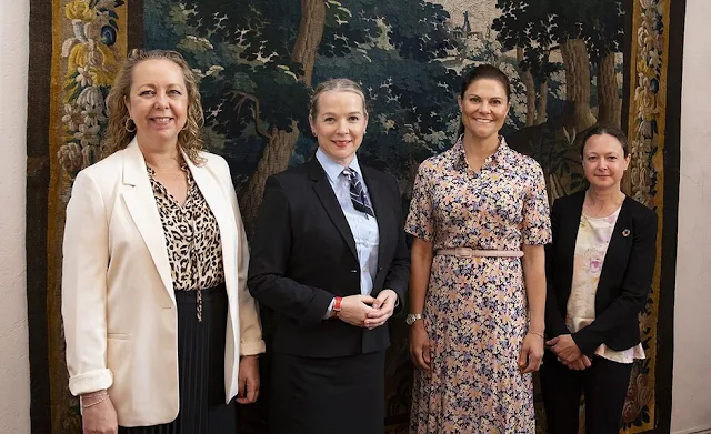 Crown Princess Victoria wore a floral print crepe dress by Arket. Ministerial Councilor Sigrún Rawet and Chancellor Karin Snellman