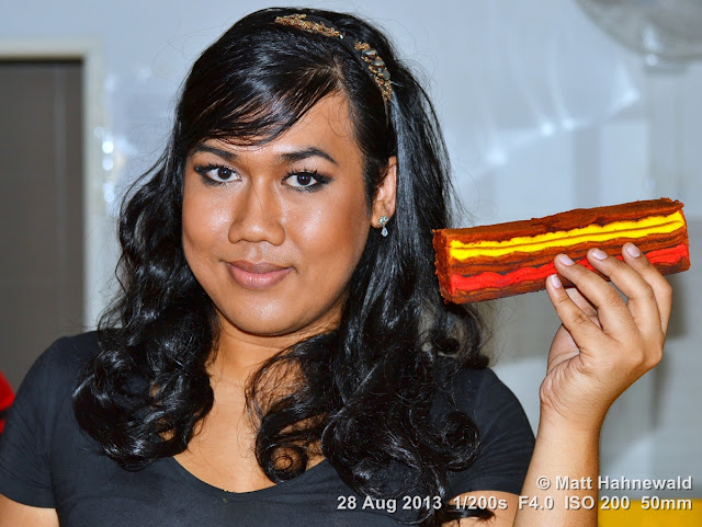 © Matt Hahnewald, Facing the World, people, street portrait, closeup, Asia, Malaysia, Kuching, sexual ambiguity, beautiful, ambiguous, long hair, genderqueer, stripe cake, kek lapis, transgender