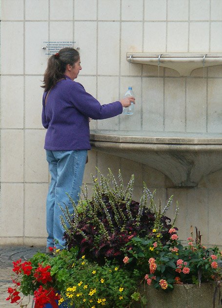 Collecting water from the public fountain at La Roche Posay, Vienne, France. Photo by Loire Valley Time Travel.