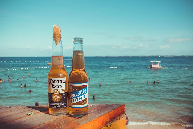 https://www.pexels.com/photo/two-corona-extra-and-san-mig-light-beers-on-top-of-brown-wooden-plank-near-beach-767239/