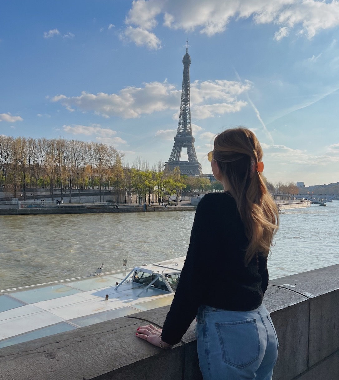 Fran Acciardo girl looking out at the seine with Eiffel Tower in the background