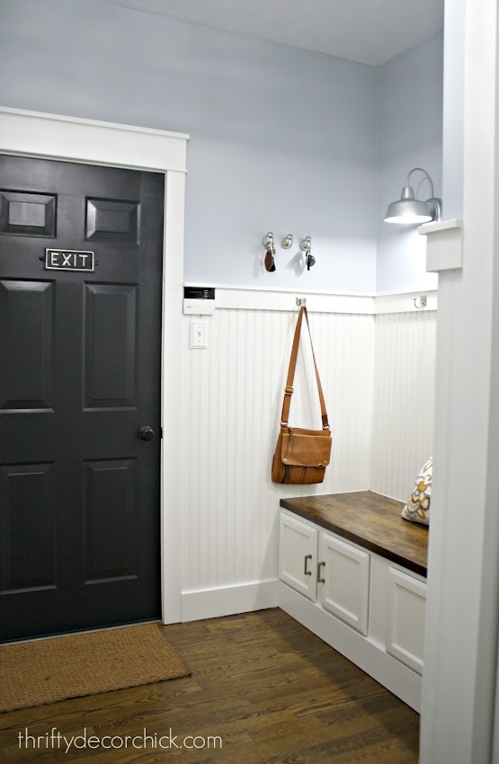 black door white trim blue walls in mudroom
