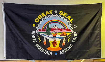 Photograph by the author of a black banner showing the Great Seal of the White Mountain Apache Tribe