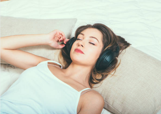 Girl is sleeping with Noise-Canceling headphones on.