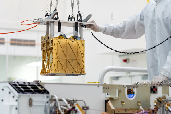 At NASA's Jet Propulsion Laboratory near Pasadena, California, the MOXIE instrument is about to be installed inside the chassis of the Perseverance Mars rover.