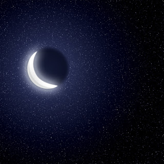 A bright crescent moon glows amid a bed of twinkling stars.