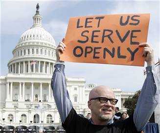 Protester holds sign reading 'Let us serve openly'