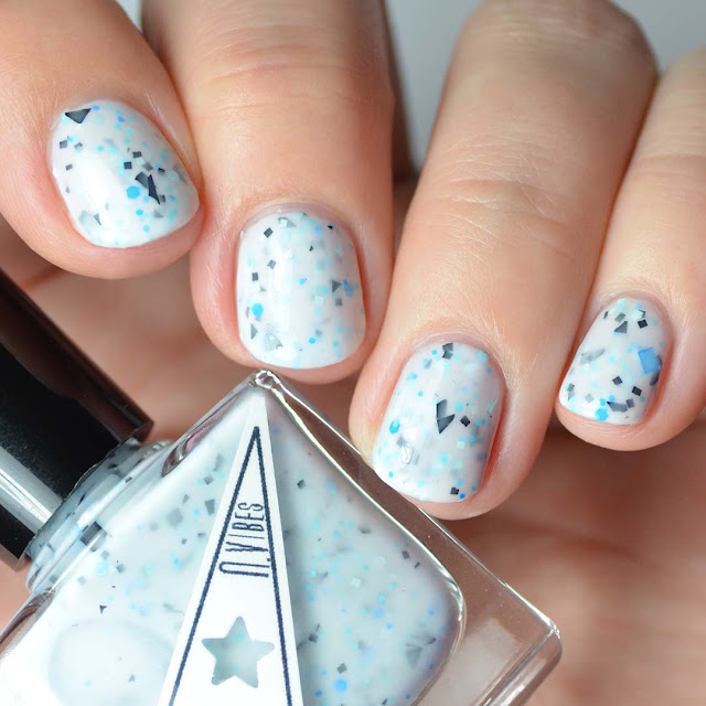 white nail polish with blue and black glitter