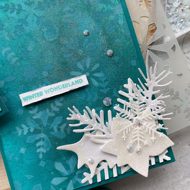 Winter Wonderland Holiday Cards made with: Tim Holtz modern festive die, rock candy distress glitter, distress spray stain, distress oxide, distress mica stain; Scrapbook.com solar white cardstock, wordfetti fa la la stamp, peppermint winter stencil, cools jewels smooth cardstock; Pinkfresh jewels; Pima watercolor paper