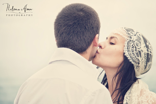 bride kissing groom at the beach