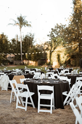 simple black reception tables with white chairs