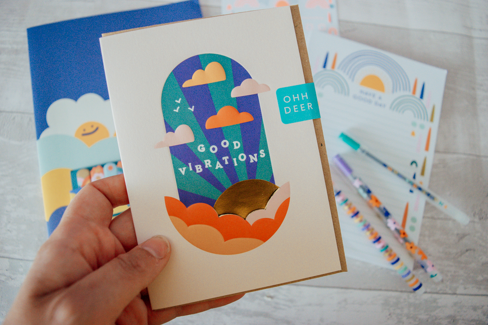 A greeting card with the quote 'good vibrations' on the front