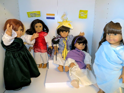 All five dolls in their costumes standing and sitting