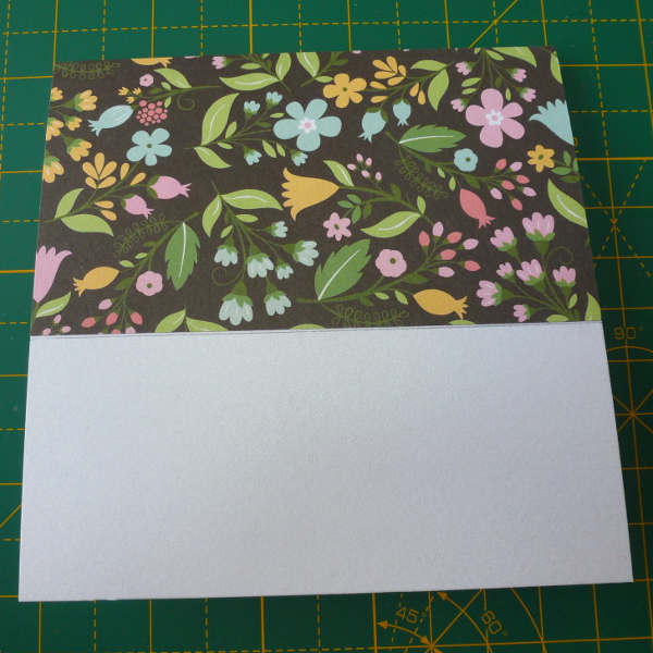 Covering the top of a card blank with patterned black floral scrapbook paper