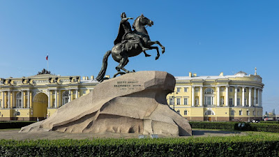 a monument to Peter I "The Bronze Horseman" behind St. Isaac's Cathedral