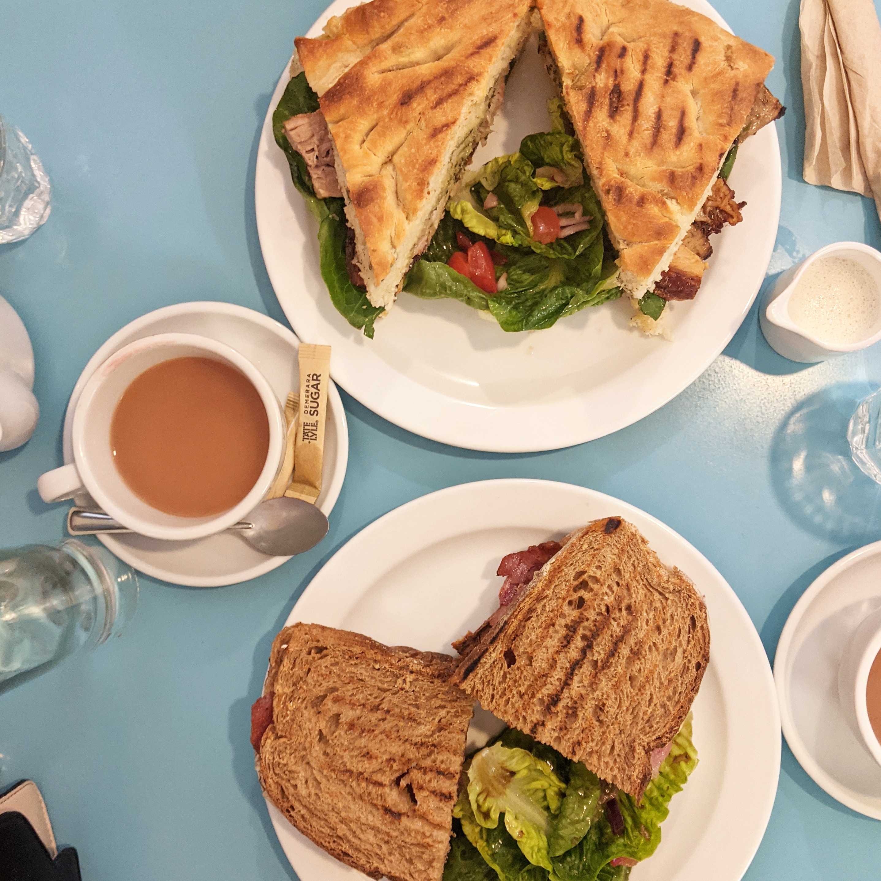 breakfast sandwiches on a blue table at Jam Cafe, one of the best east london breakfast spots