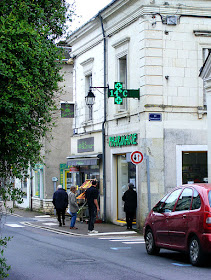 Customers waiting to enter a pharmacy during the COVID19 lockdown.  Indre et Loire, France. Photographed by Susan Walter. Tour the Loire Valley with a classic car and a private guide.