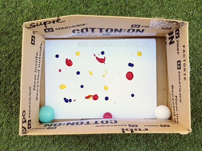 paint and balls in cardboard box